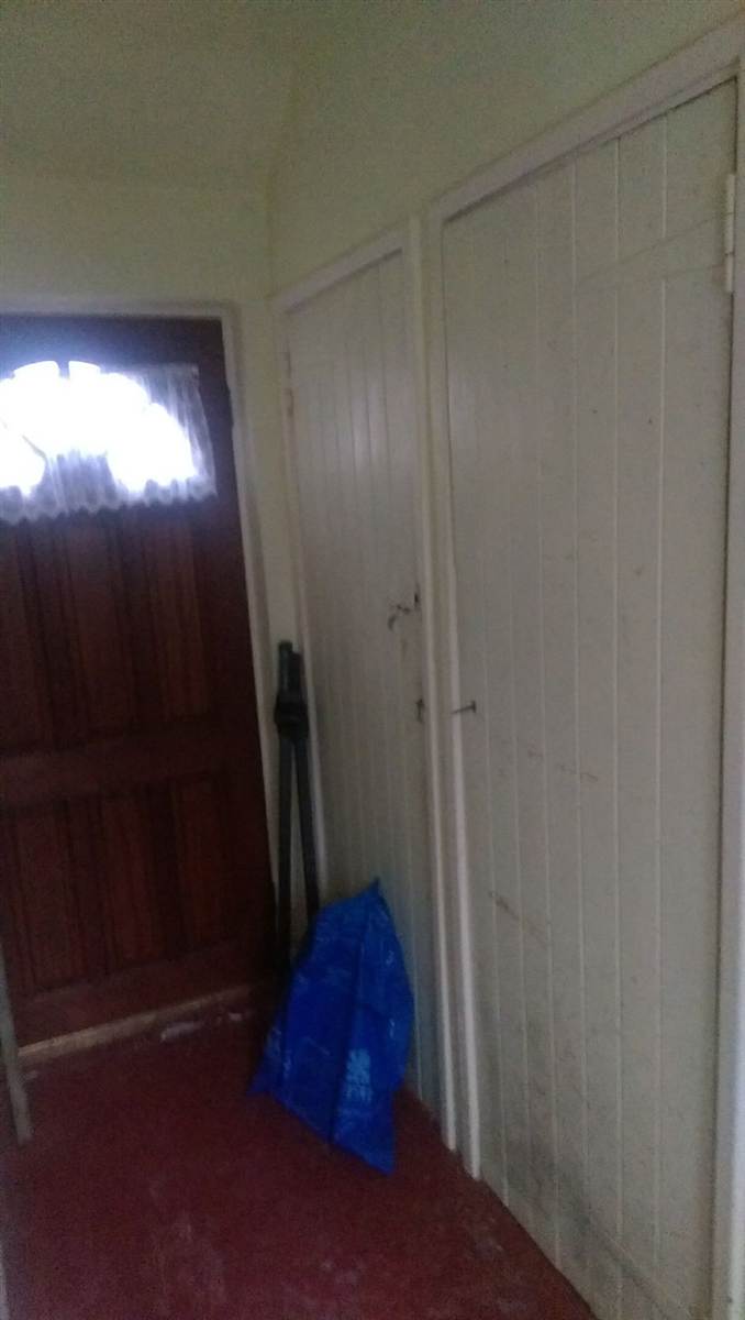 Before — the original outbuilding attached to the house, with old panelled doors and no plumbing